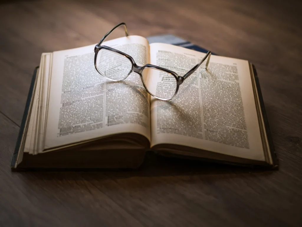 Reading glasses resting on an open book